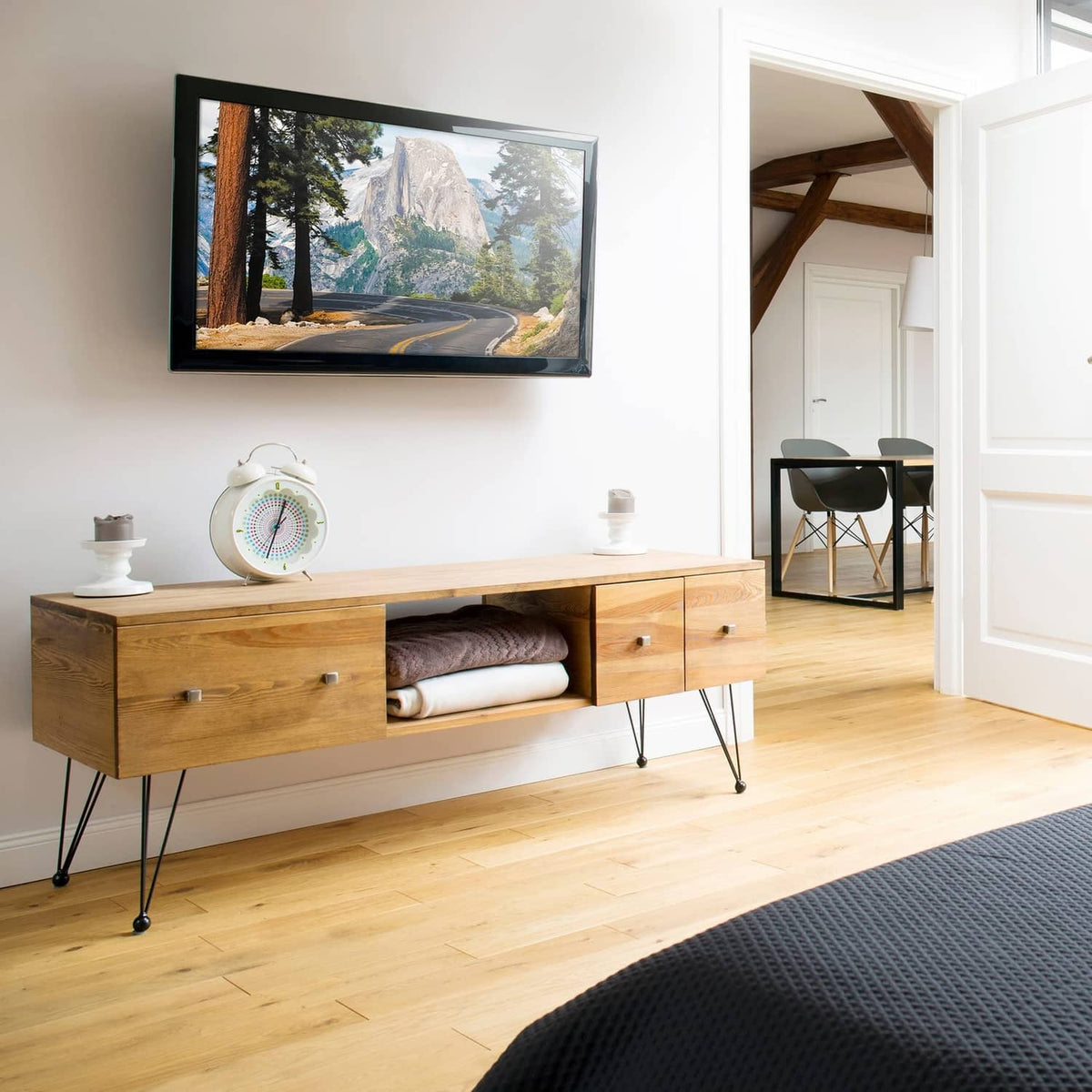 Low-profile TV wall mount holding a flat-screen TV on the wall with bracket arms