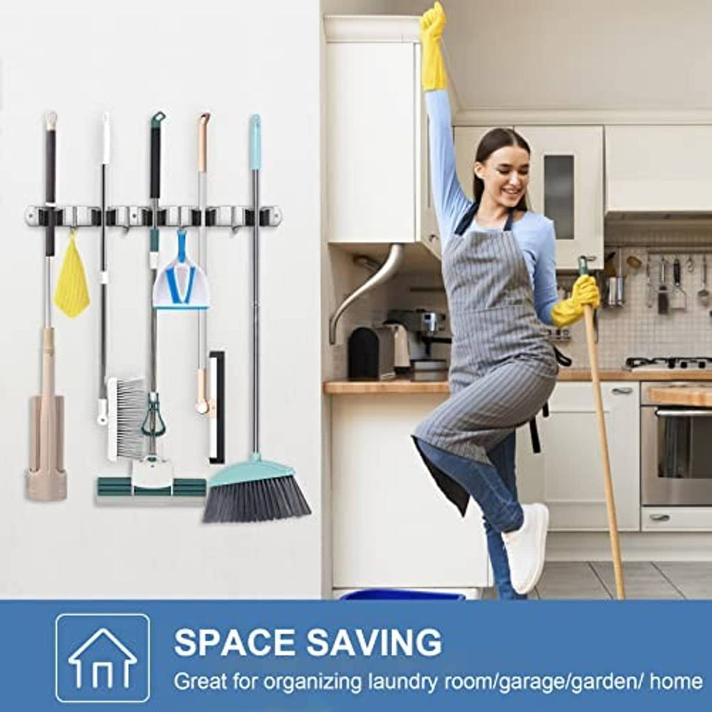 Stainless steel wall broom organizer rack with hooks holding brooms and mops