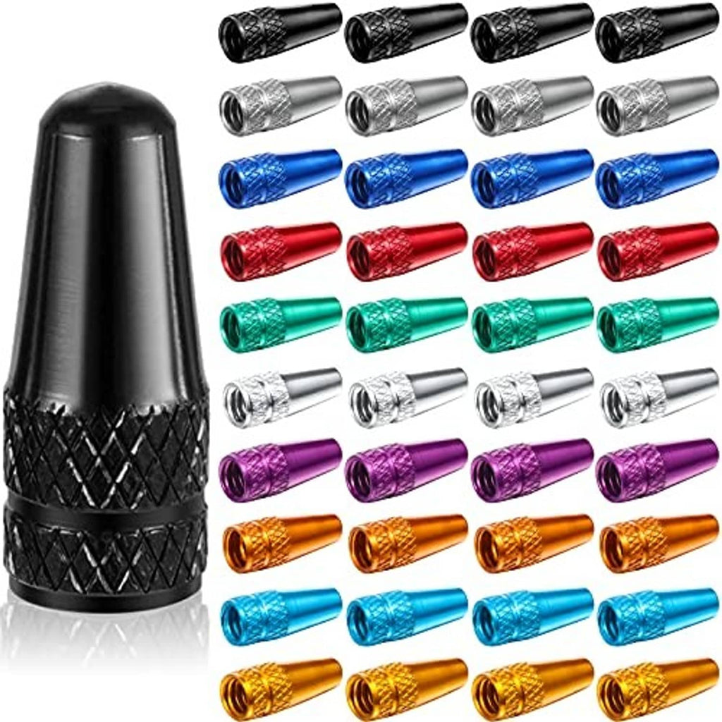 Rocket-style Presta valve caps in multiple anodized colors, black cap shown close-up