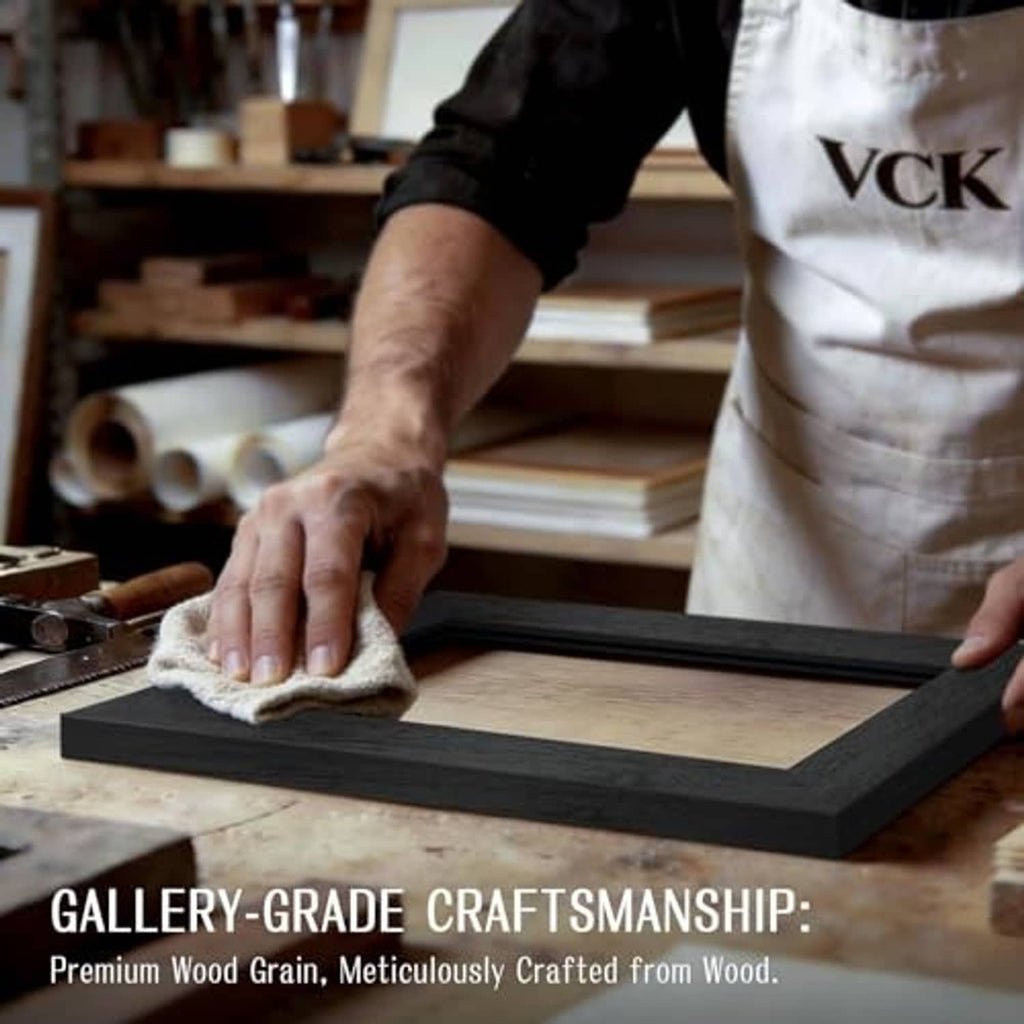 Black wood picture frame being cleaned on a workbench