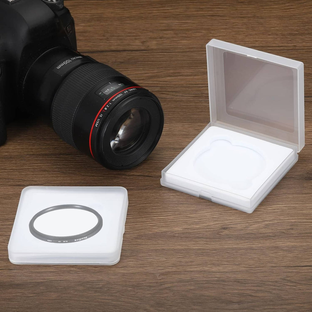 67mm lens filter case on tabletop beside camera lens, white insert inside