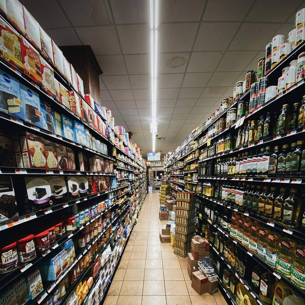Overhead white LED shop light illuminating a retail aisle