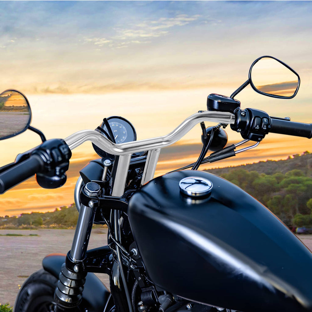 Chrome MX T-bar handlebar installed on a motorcycle, showing curved central rise