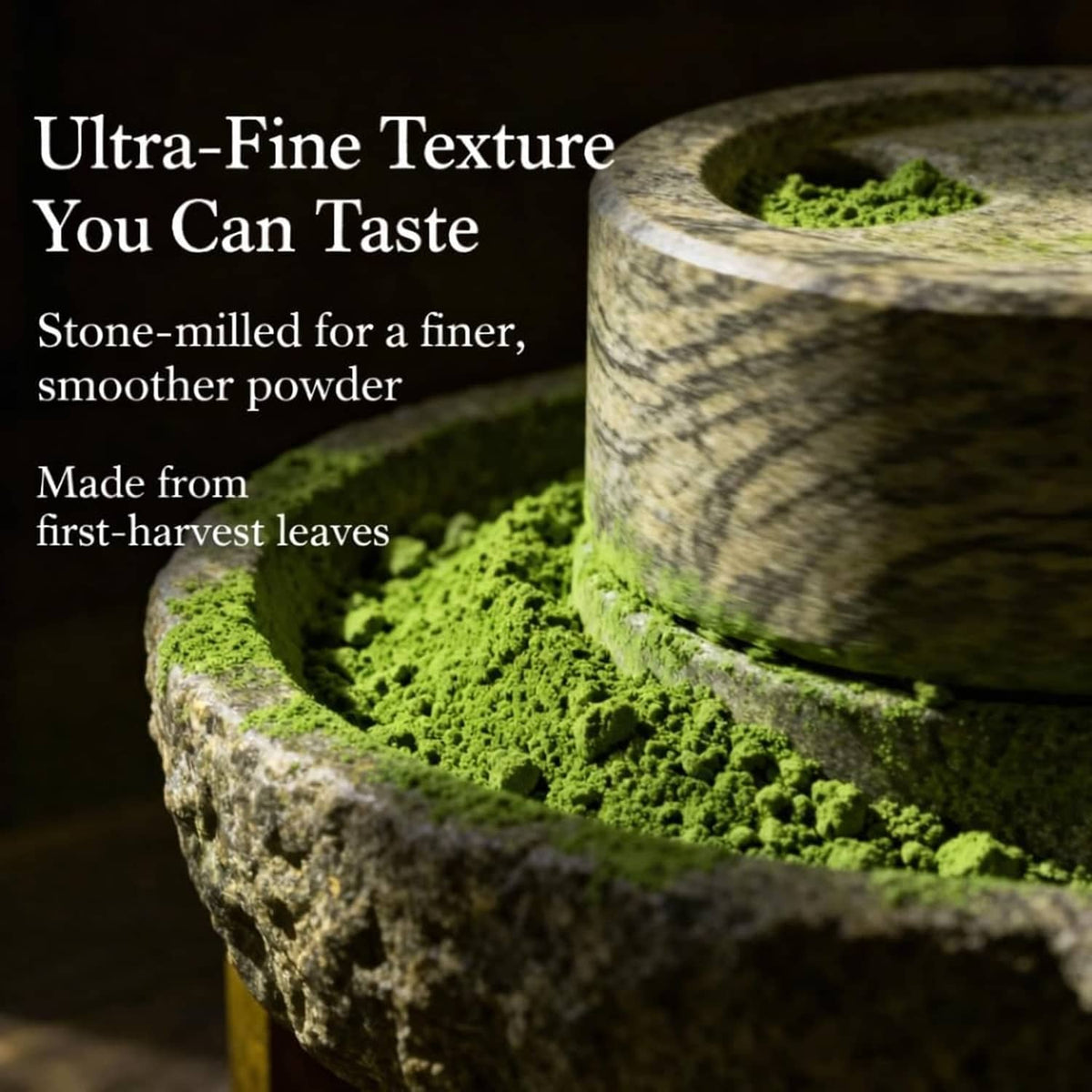 Ultra-fine green matcha powder in a stone grinder with textured stone surfaces