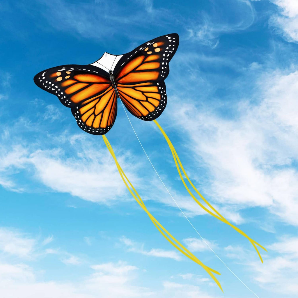 Monarch butterfly kite with orange patterned wings, black outline, and long yellow tails