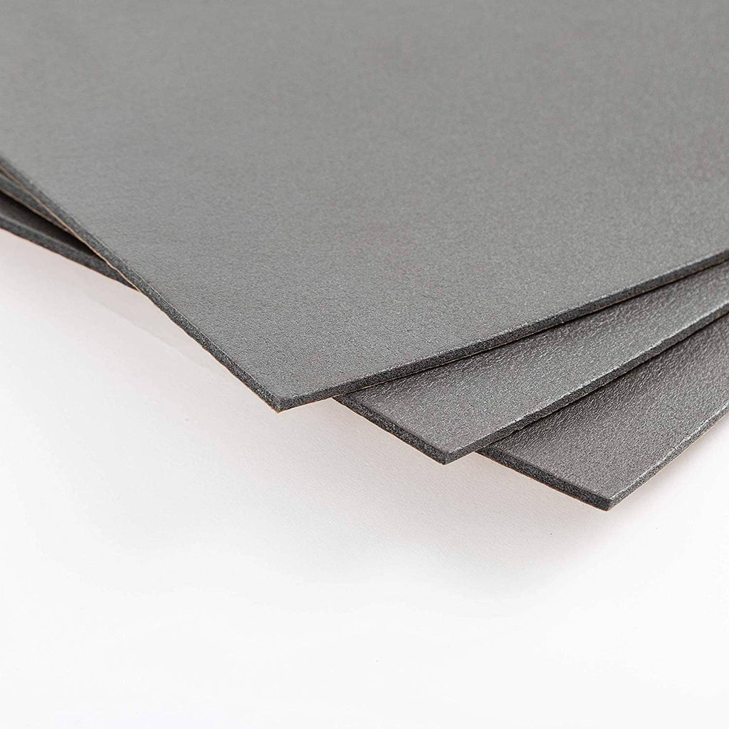 Layered dark gray sound insulation sheets with narrow brown adhesive border
