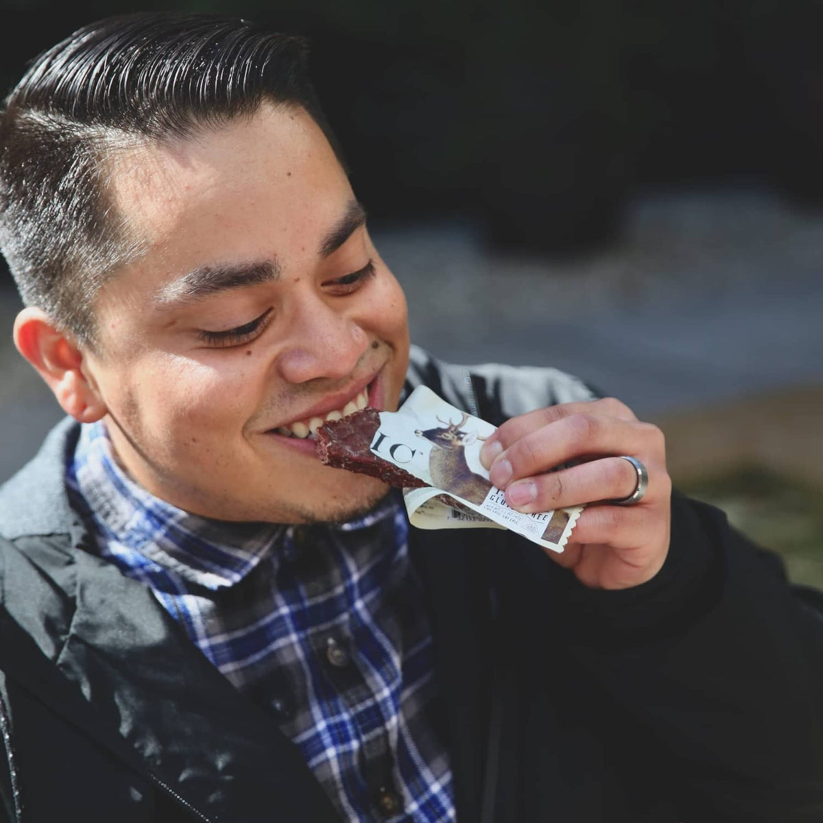 Man eating an Epic Venison Sea Salt + Pepper Bar from a snack packet