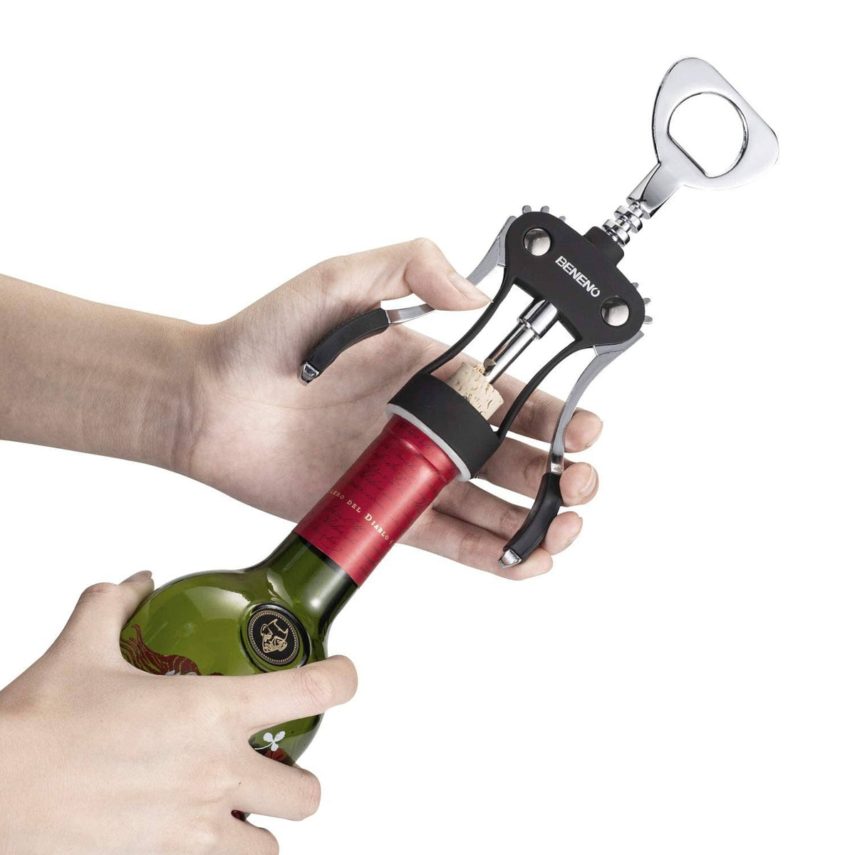 Handheld midnight black wing corkscrew pulling a cork from a wine bottle