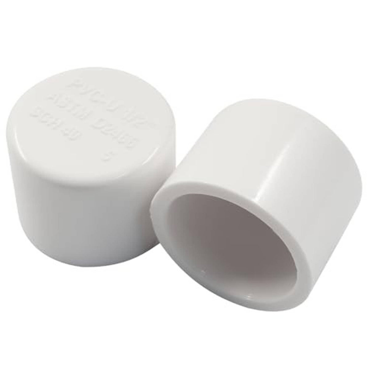 Two white PVC pipe end caps with embossed markings on top