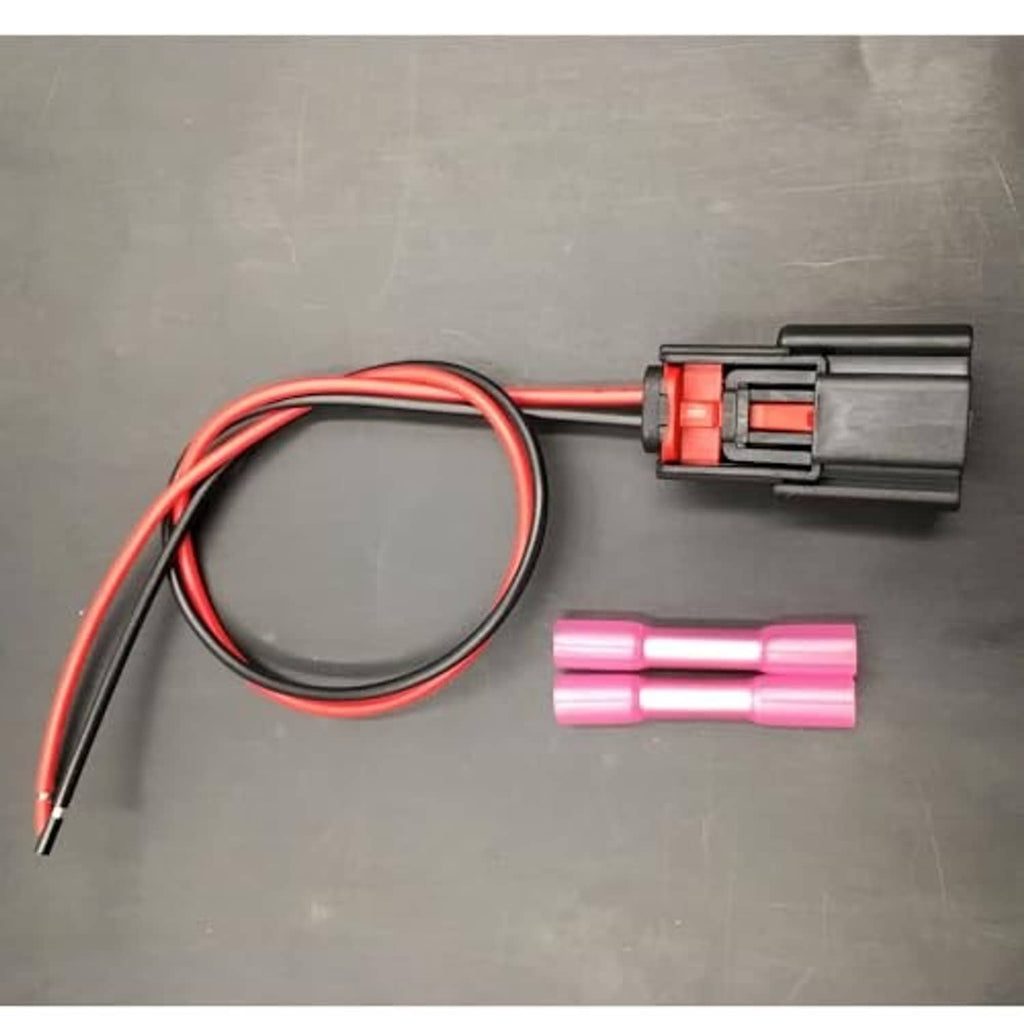 Fog light wiring harness with black connector, red/black cable loop, and two pink terminal sleeves