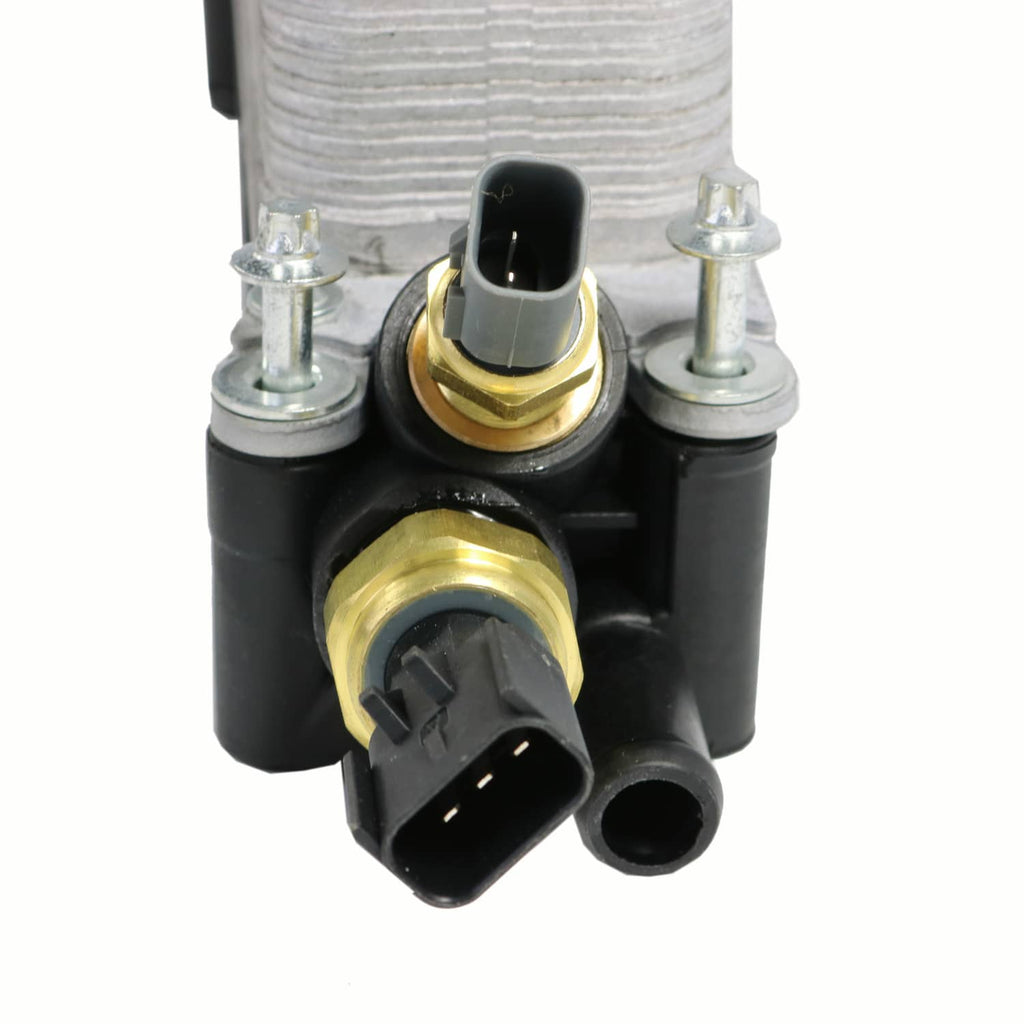 Oil filter adapter housing with brass fittings and black electrical connector
