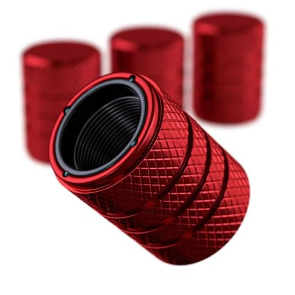 Ruby red tire valve stem cap with textured pattern and black valve opening