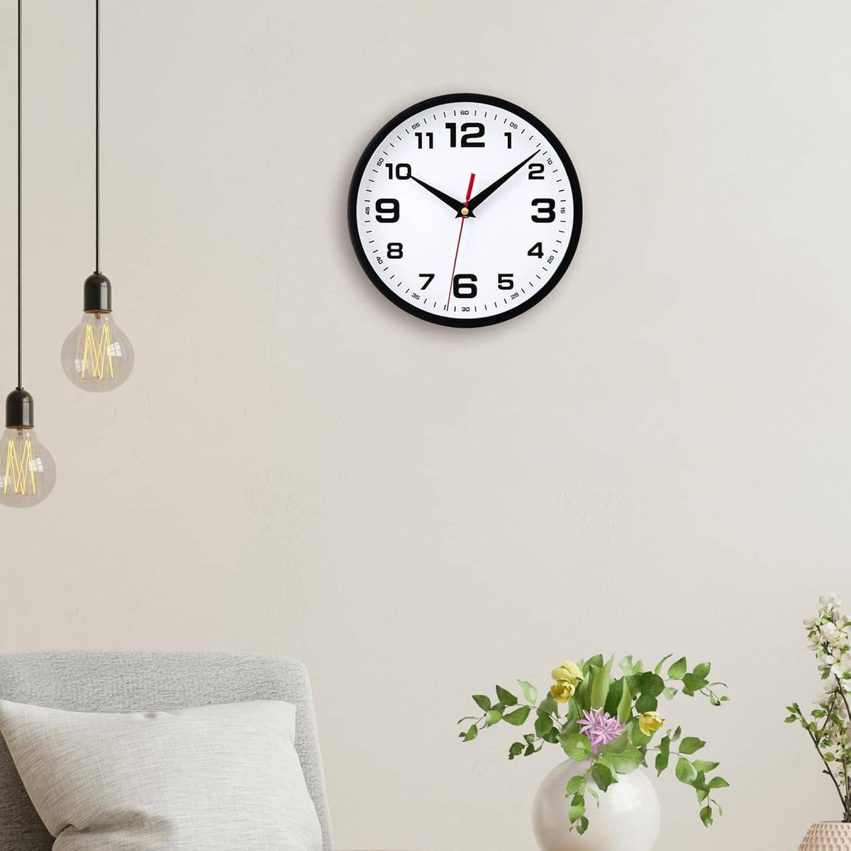 Small black analog wall clock with white dial, large numerals, red second hand