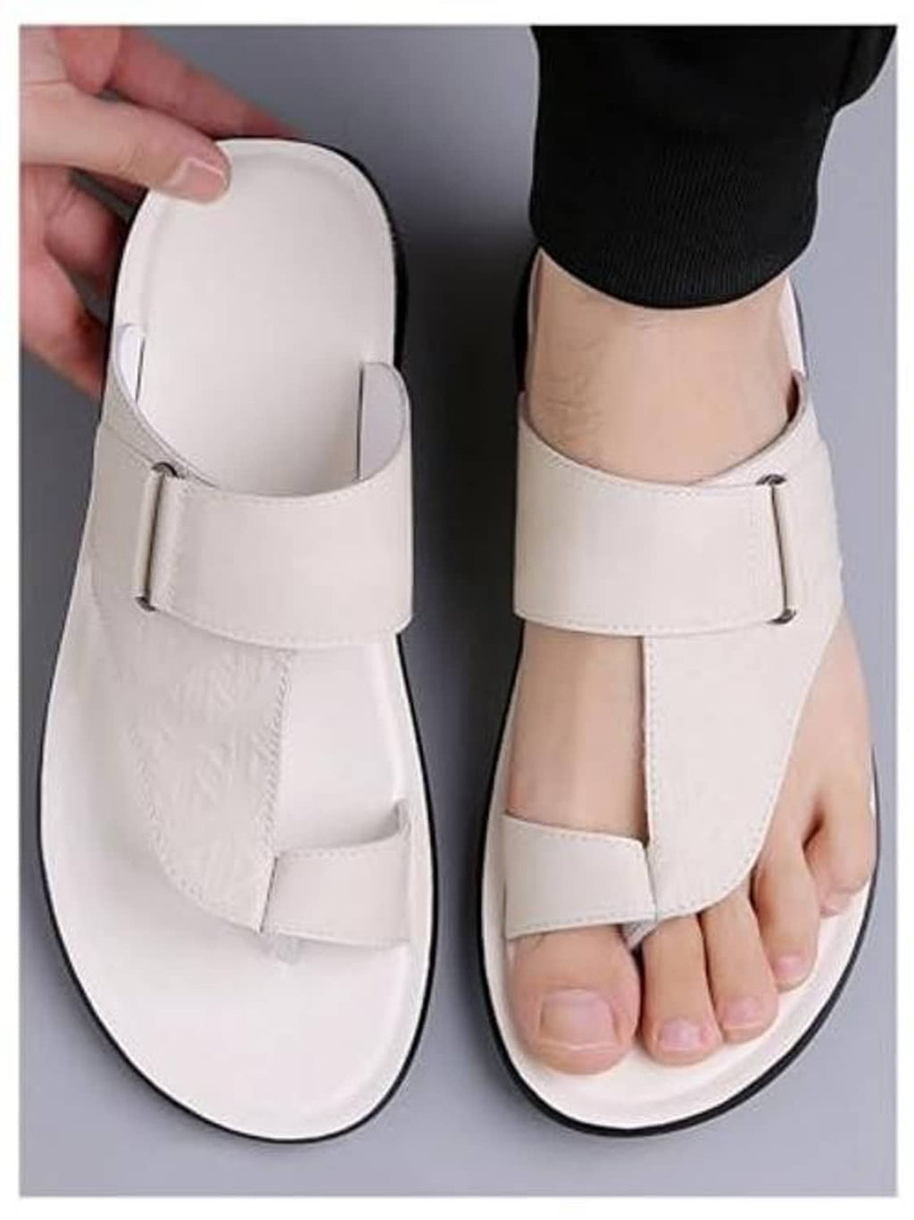 White open toe thong sandals with front strap, worn on one foot