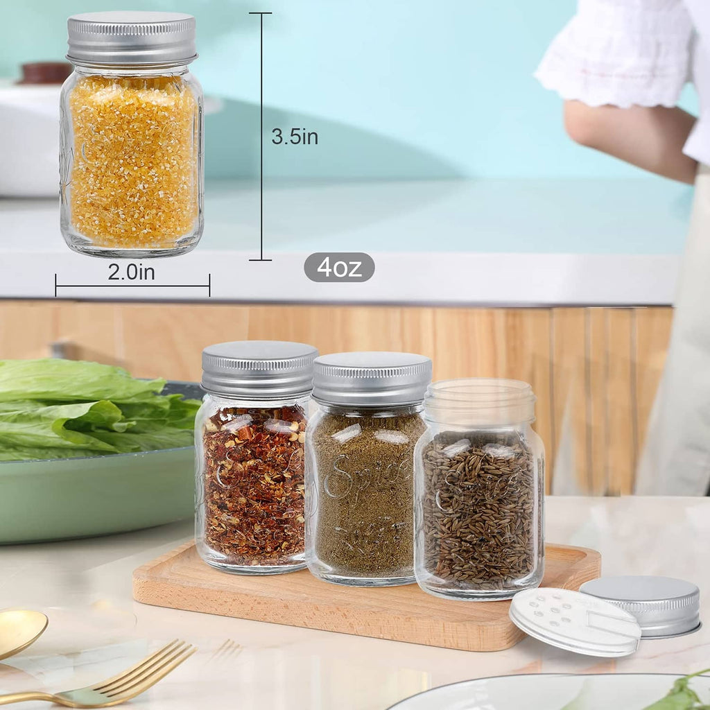 Clear 4 oz glass mason spice jar with silver lid and seasoning granules inside