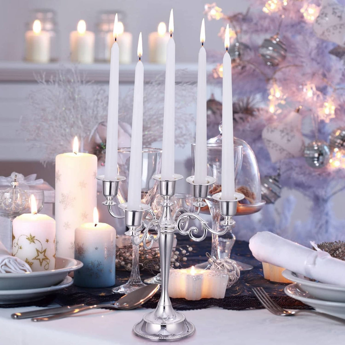White taper candles in metal candelabra, lit flames, slim dripless candles set