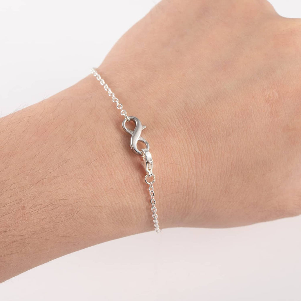 Sterling silver lobster clasp extender on chain bracelet, worn on wrist