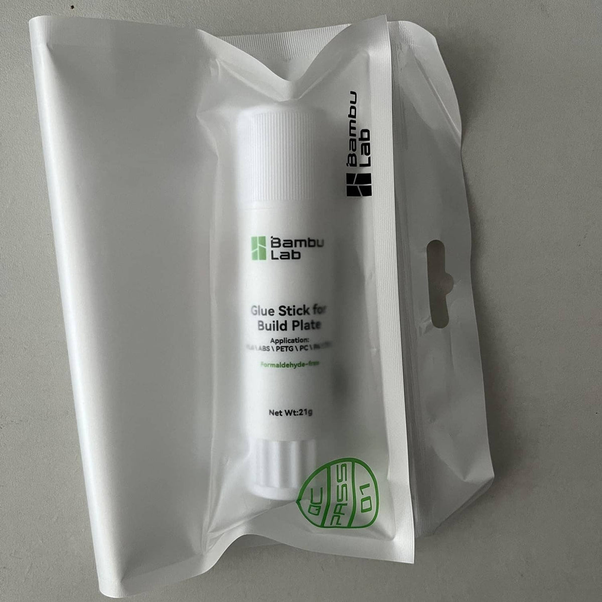 Bambu Lab glue stick for build plate, white bottle inside clear retail bag