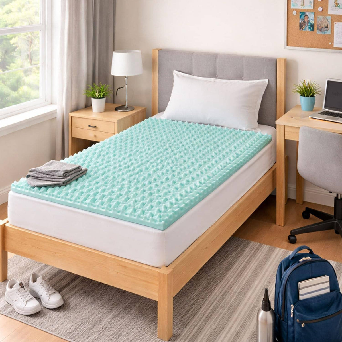 Light teal egg-crate foam mattress topper on a bed in a bedroom setting.