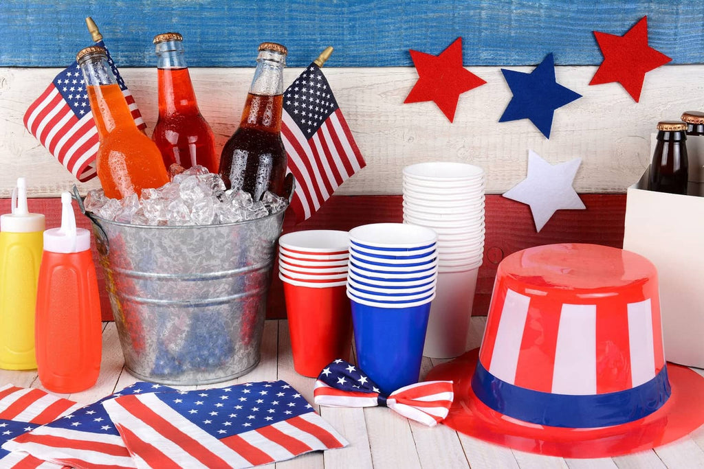 Small U.S. stick flags clustered near a table, red stripes and blue star field on poles