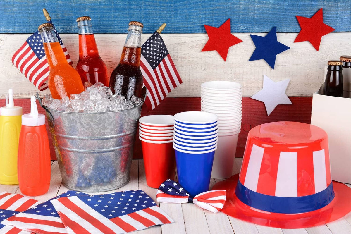 Small U.S. stick flags clustered near a table, red stripes and blue star field on poles