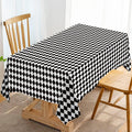 Black and white diamond check tablecloth covering a dining table