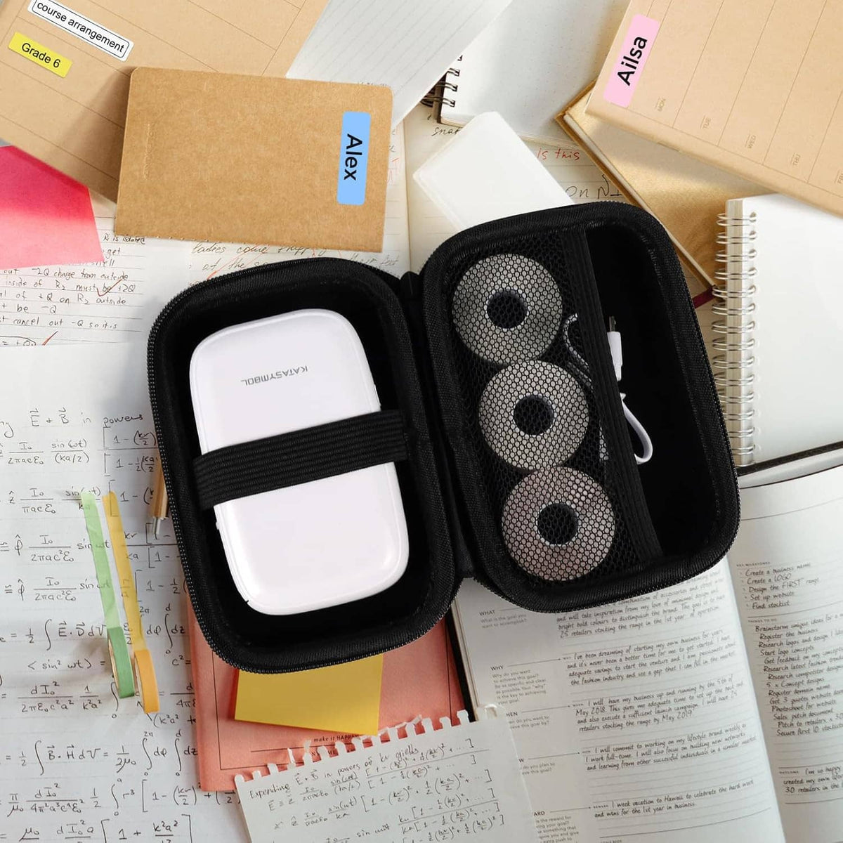 Open mint travel case with black mesh pocket holding compact label maker