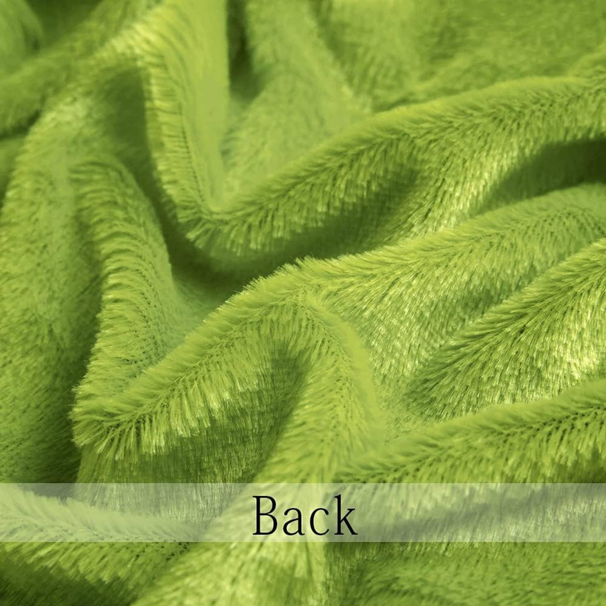 Bright green faux fur fabric swatch close-up, soft shag texture