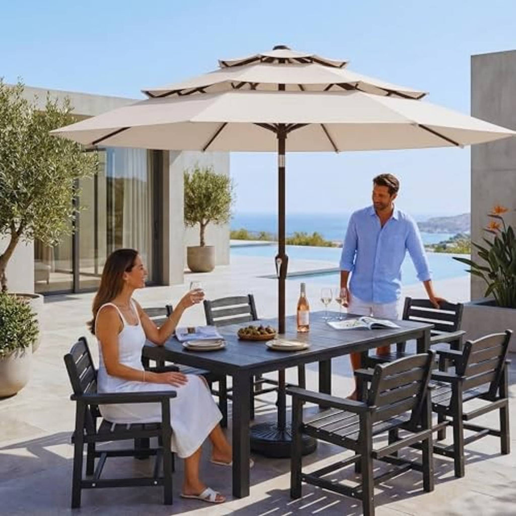 Beige 3-tier patio umbrella open over an outdoor dining table setup