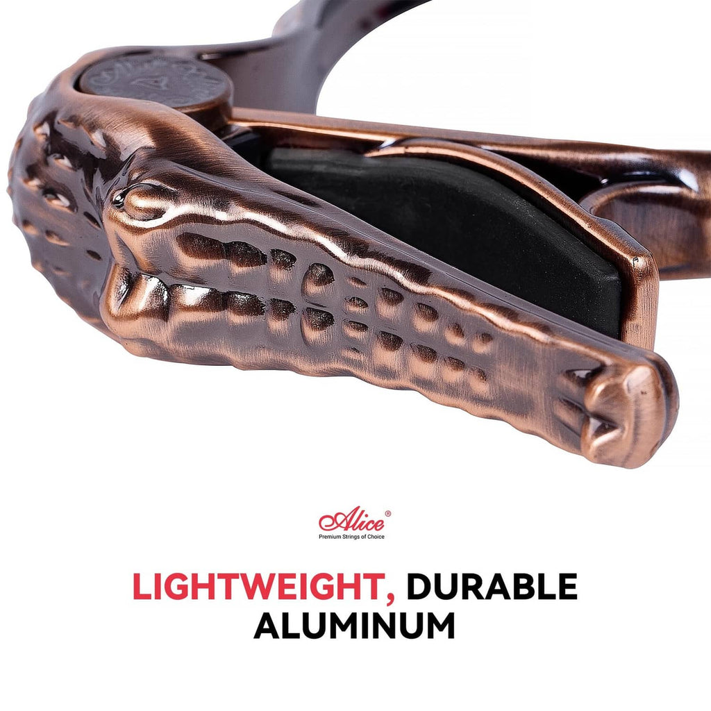 Bronze alligator-style guitar capo with black inner grip, detailed side view
