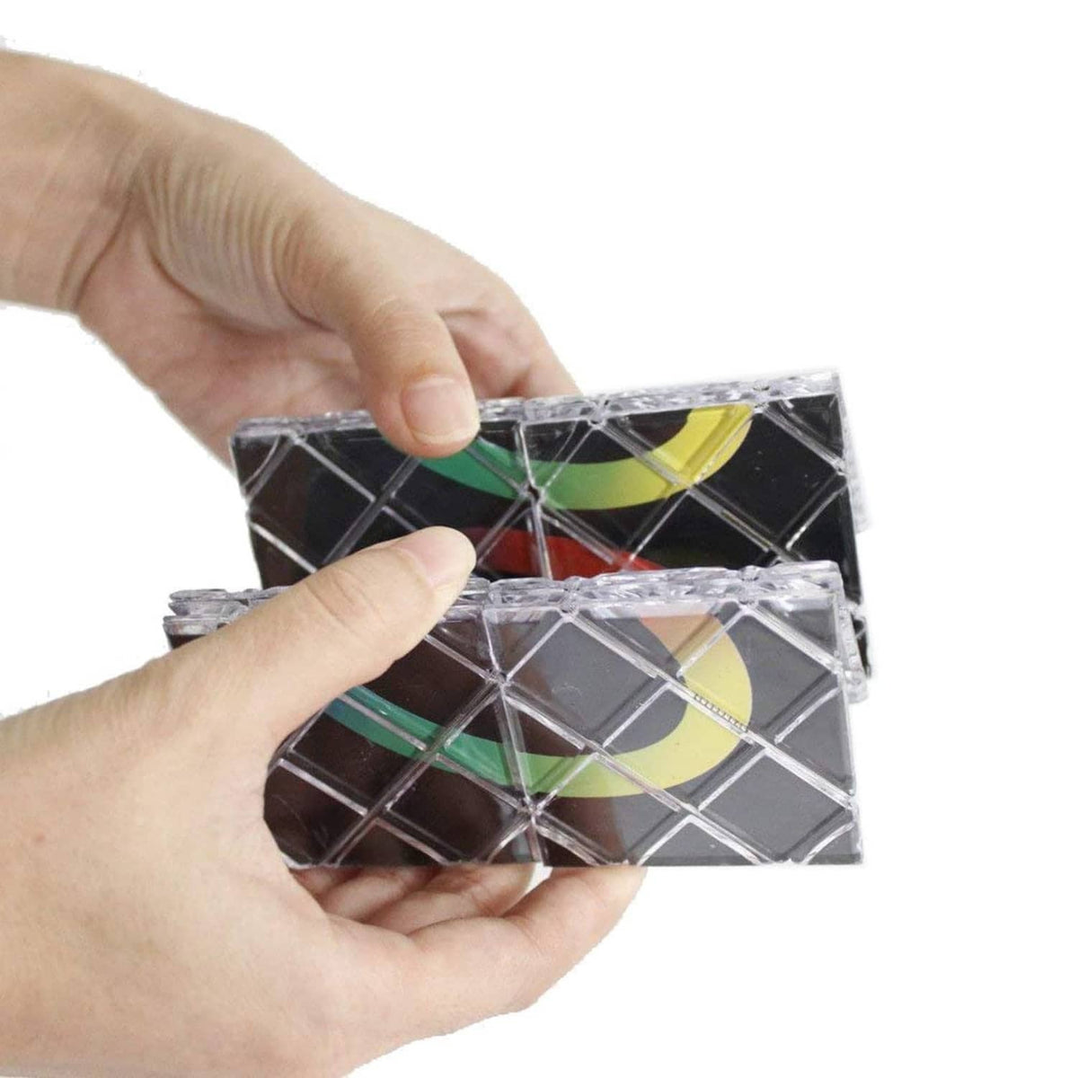 Twisty folding puzzle board, hands holding black grid with colorful ring segments