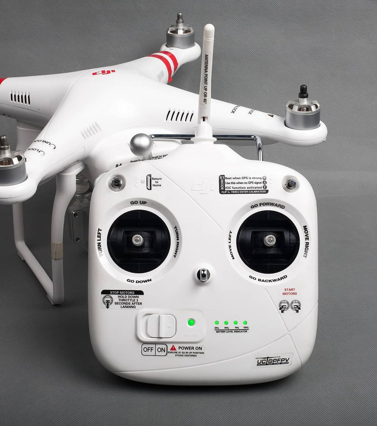 Drone body with red/black decal markings on arms and front