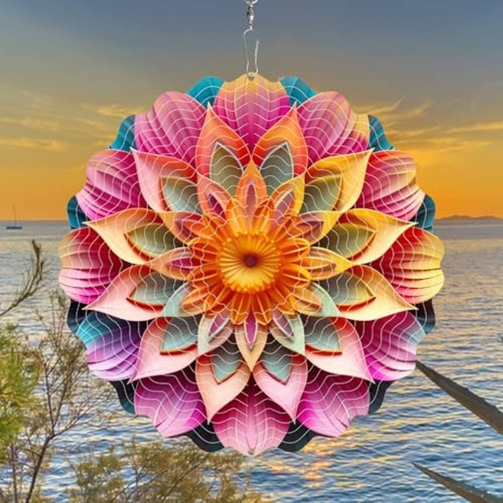 Pink, orange, and teal mandala wind spinner with layered petals, hanging outdoors