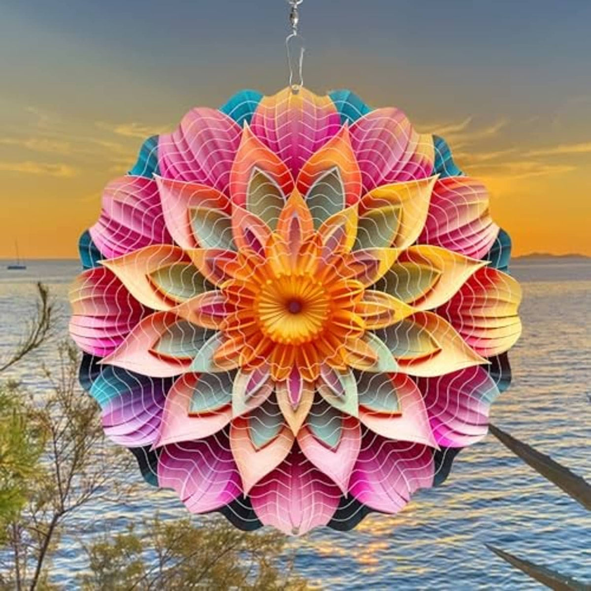 Pink, orange, and teal mandala wind spinner with layered petals, hanging outdoors