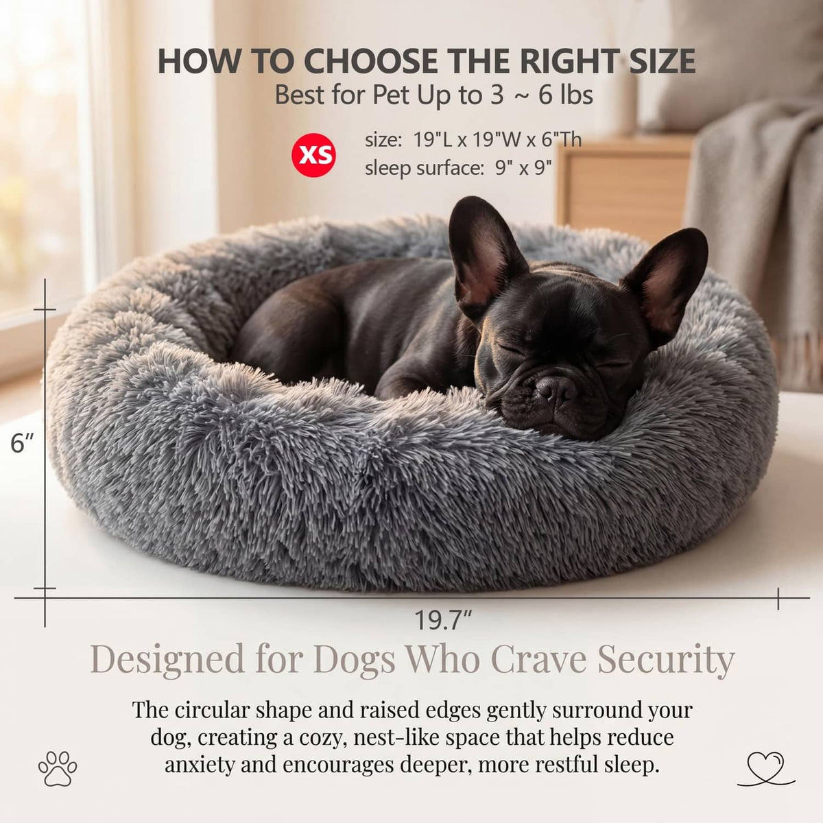 Dark grey round plush dog bed with thick bolster, small dog curled up.