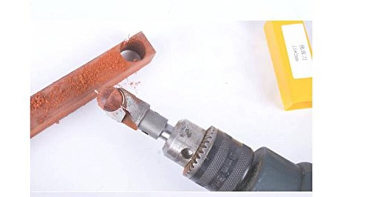 Wood bead drilling hole cutter bit attached to drill, cutting into wood block