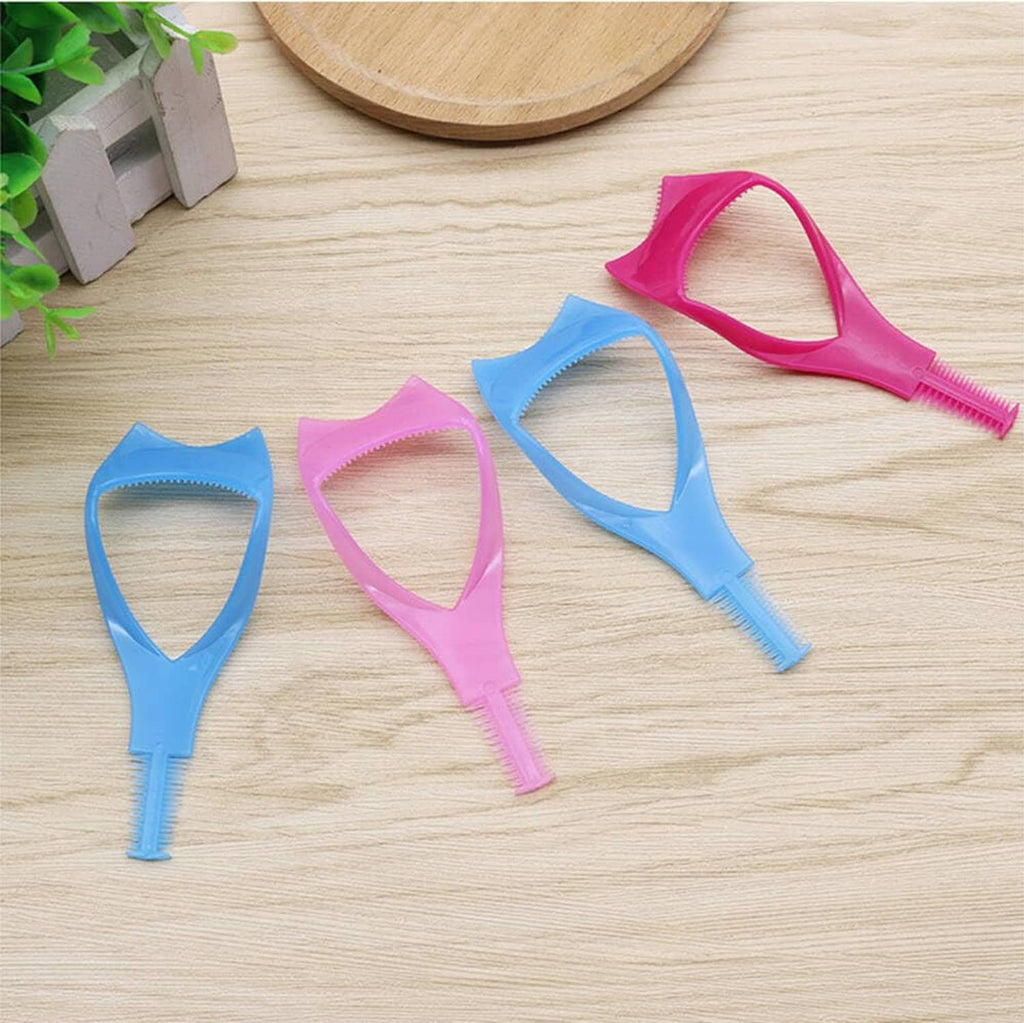 Assorted pink and blue eyelash shield tools laid out on a wooden board