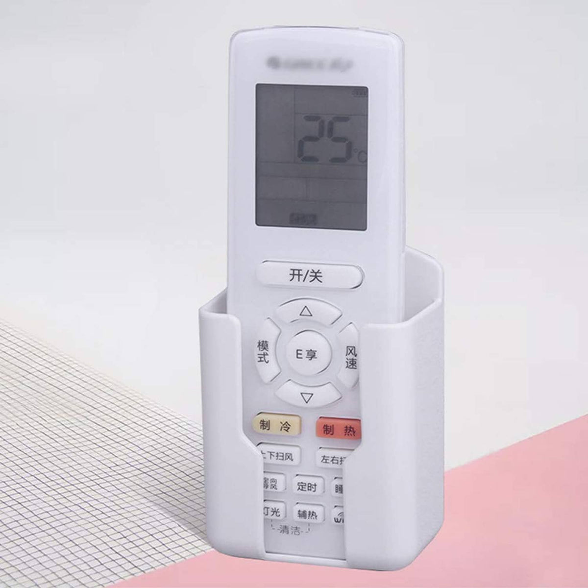 White wall-mounted remote holder holding an air-conditioner remote