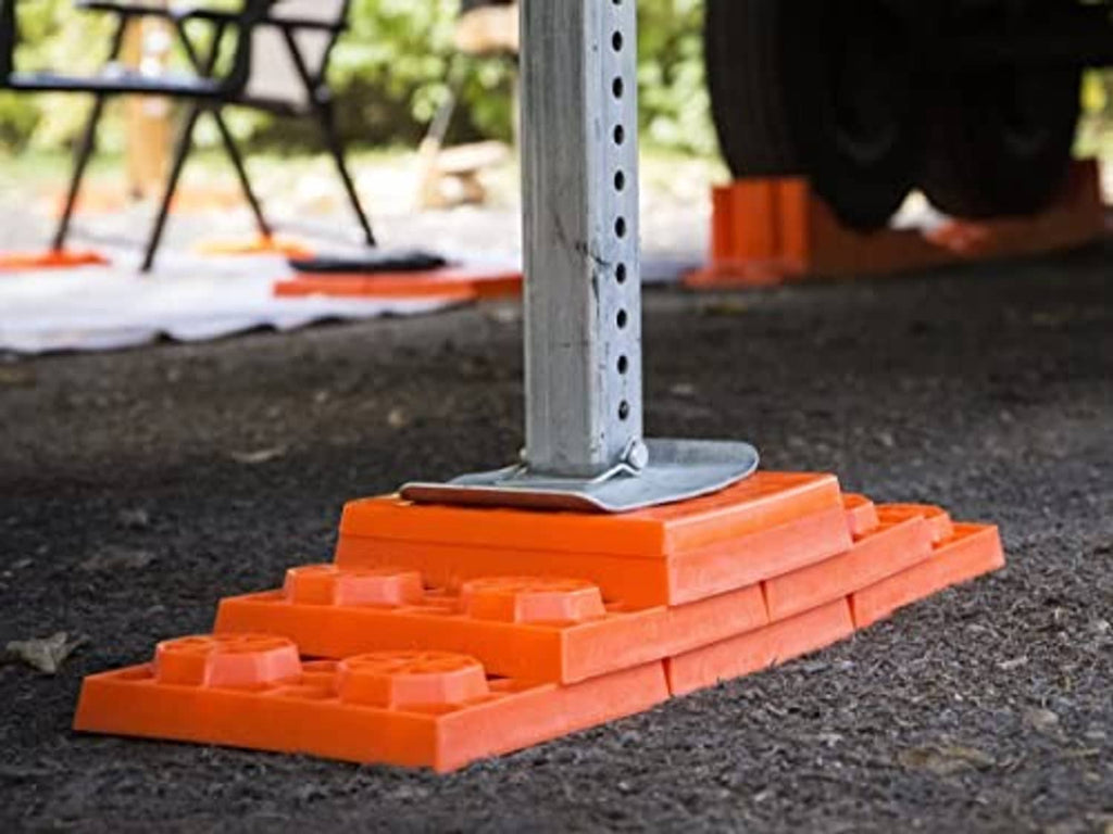 Orange RV leveling blocks with metal jack base on top
