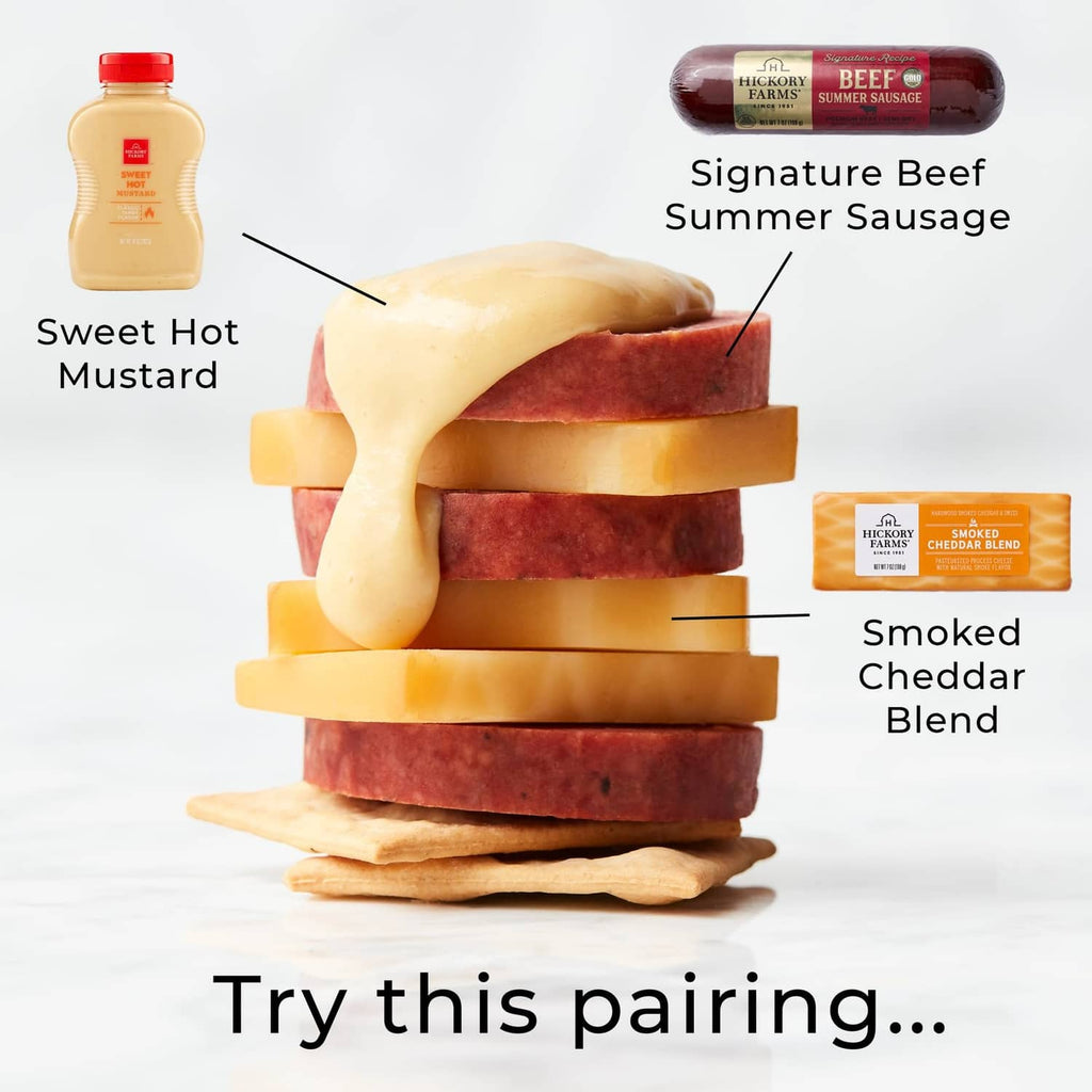 Beef Summer Sausage slices stacked with cheese pieces and sweet hot mustard bottle