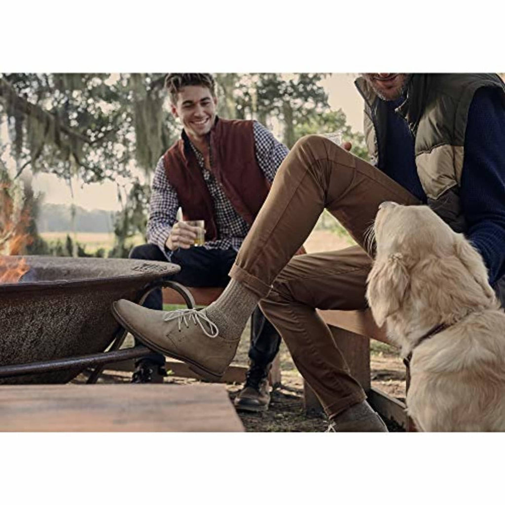 Tan crew socks on a seated outdoor wearer, ankle-length visible