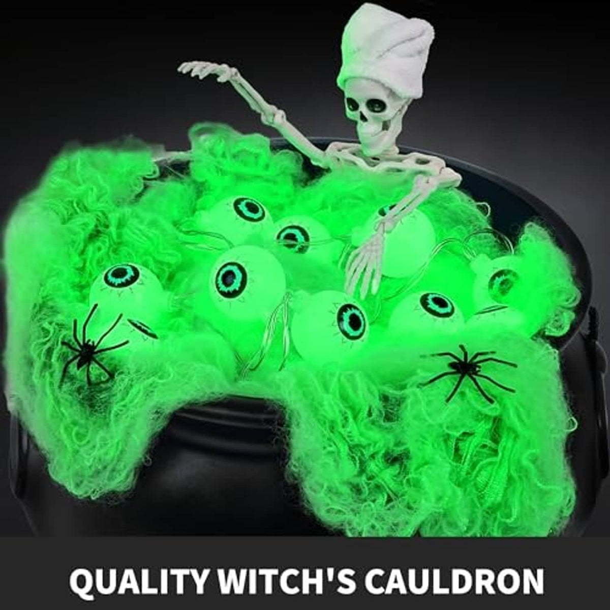 Close-up of black witch cauldron with green glowing contents and a skeleton figure
