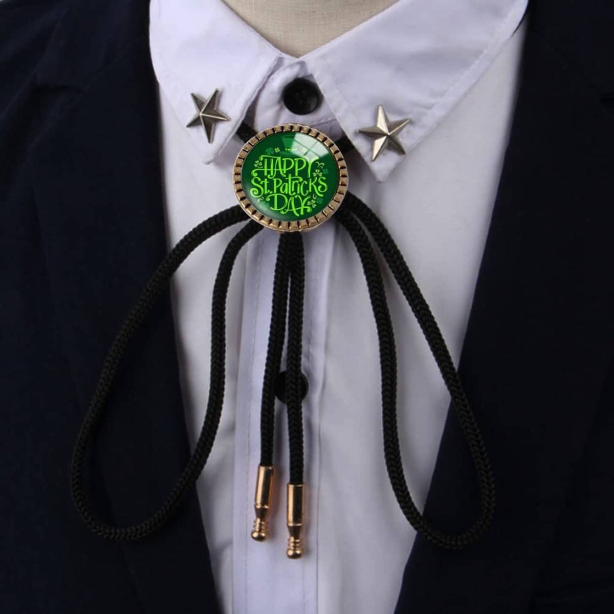 Round bolo tie buckle with green circular center and black braided cords