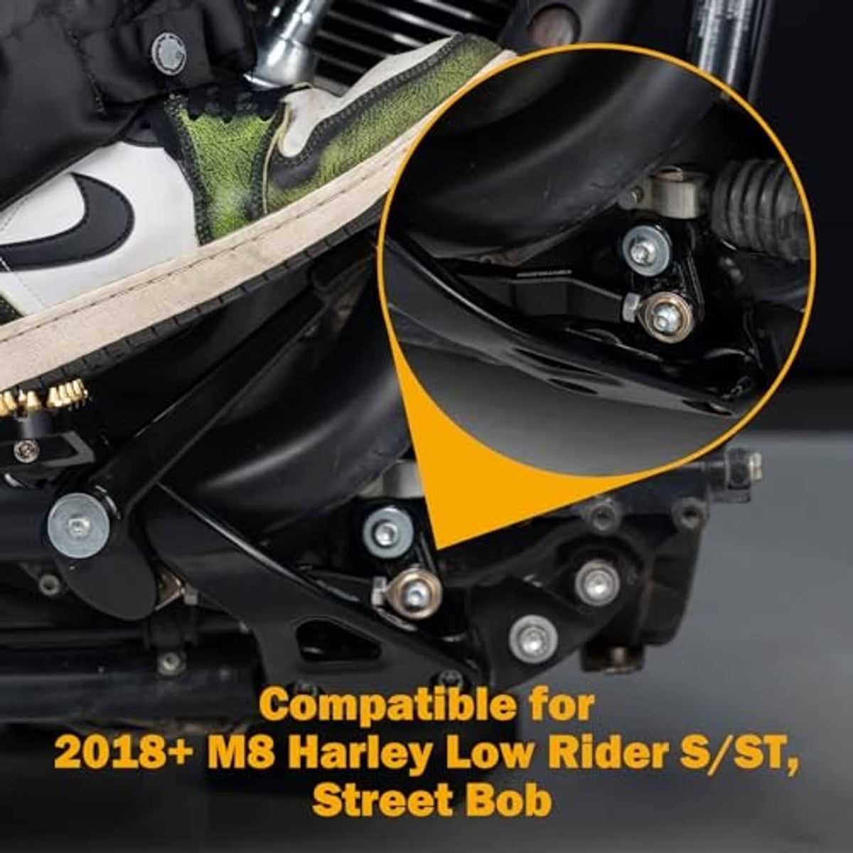 Rear brake linkage lever installed on black motorcycle, showing pivot and hardware