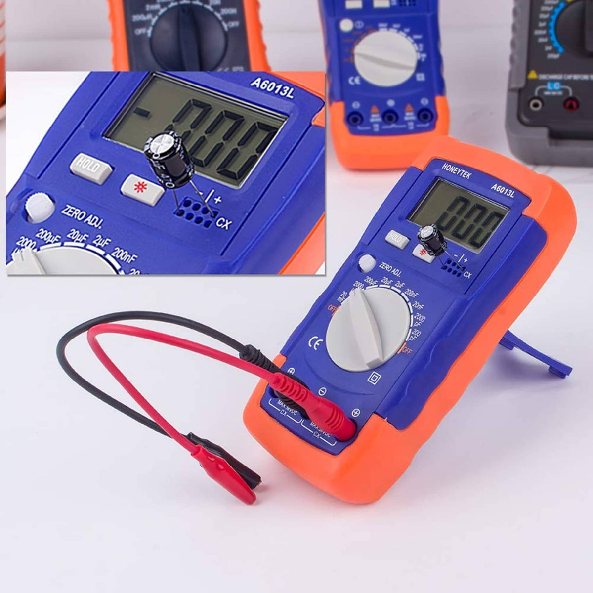 Orange and blue capacitor tester with attached red and black test leads