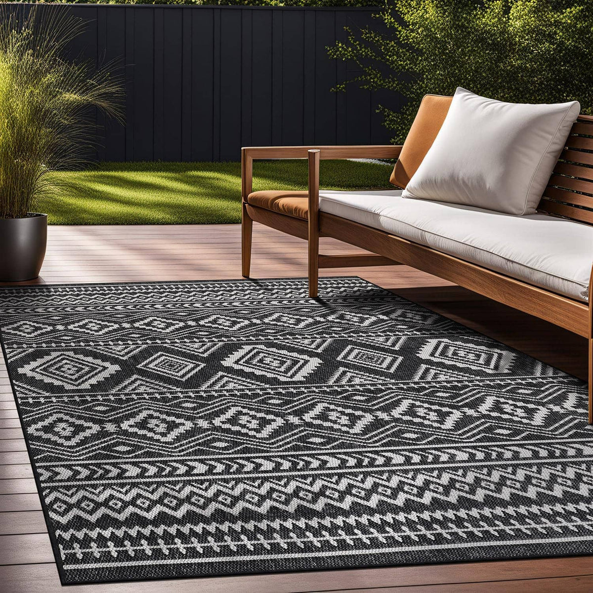 Black-and-white diamond and zigzag geometric rug on patio floor