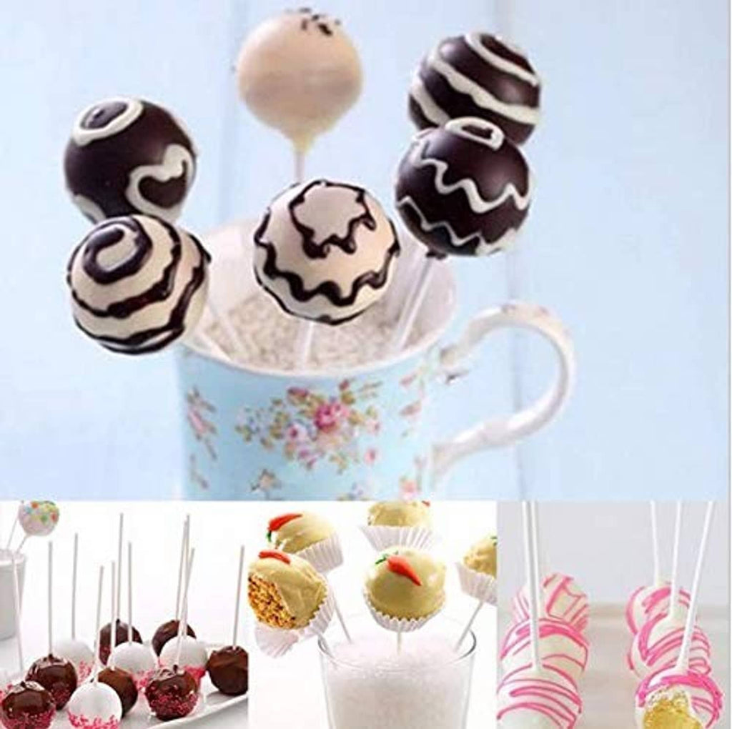 Decorated cake pops on sticks, coated in chocolate and white drizzle