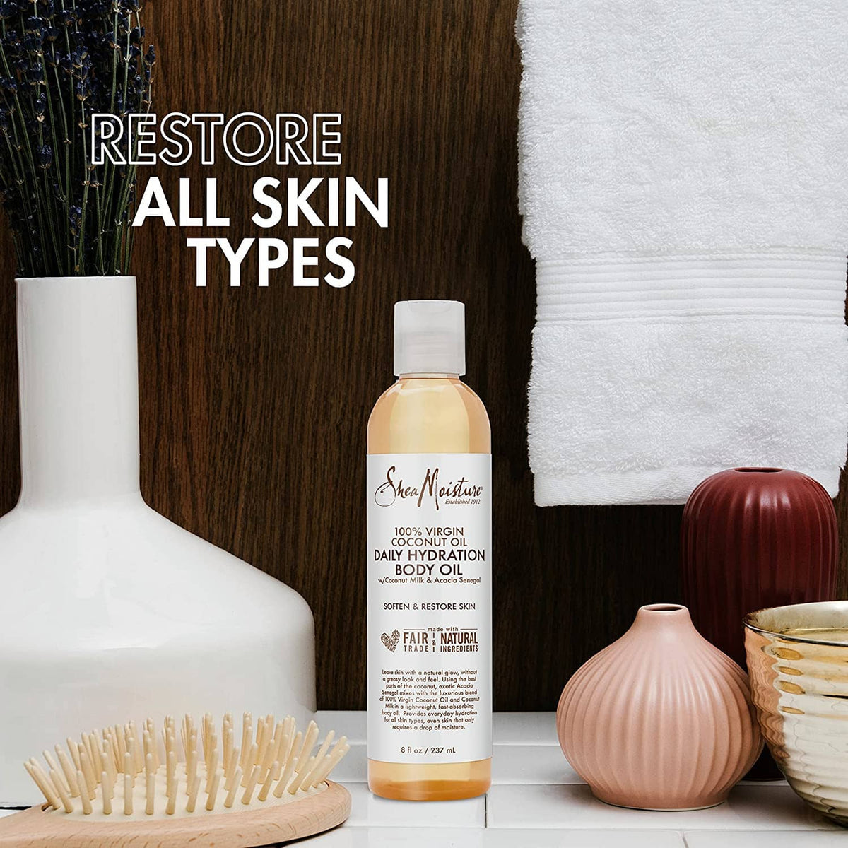 Daily hydration body oil bottle on display with surrounding skincare accessories