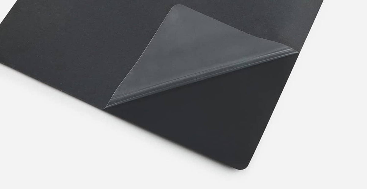 Ultra-thin hard mouse pad with visible folded edge and smooth dark surface