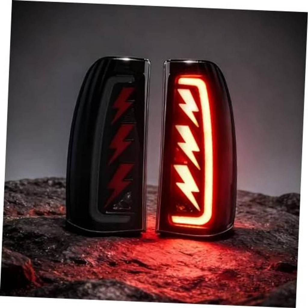 Pair of black LED tail light housings with bright red sequential arrow pattern lit